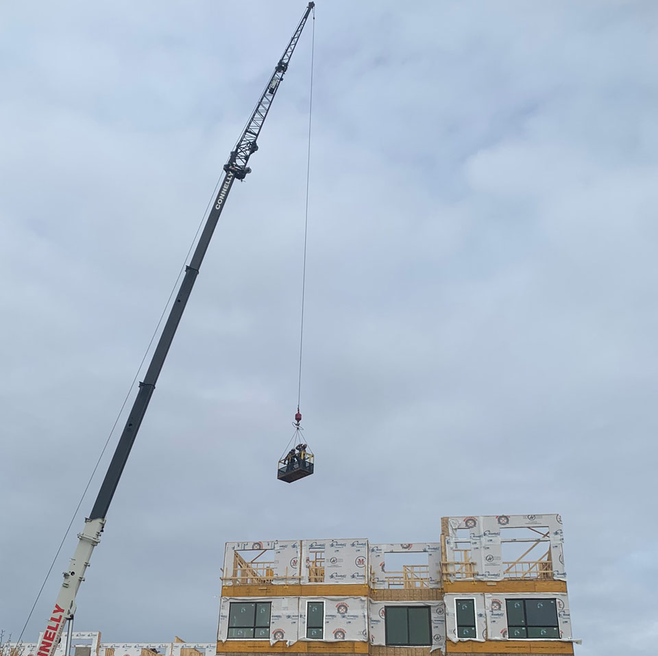 Crane dropping crew into building